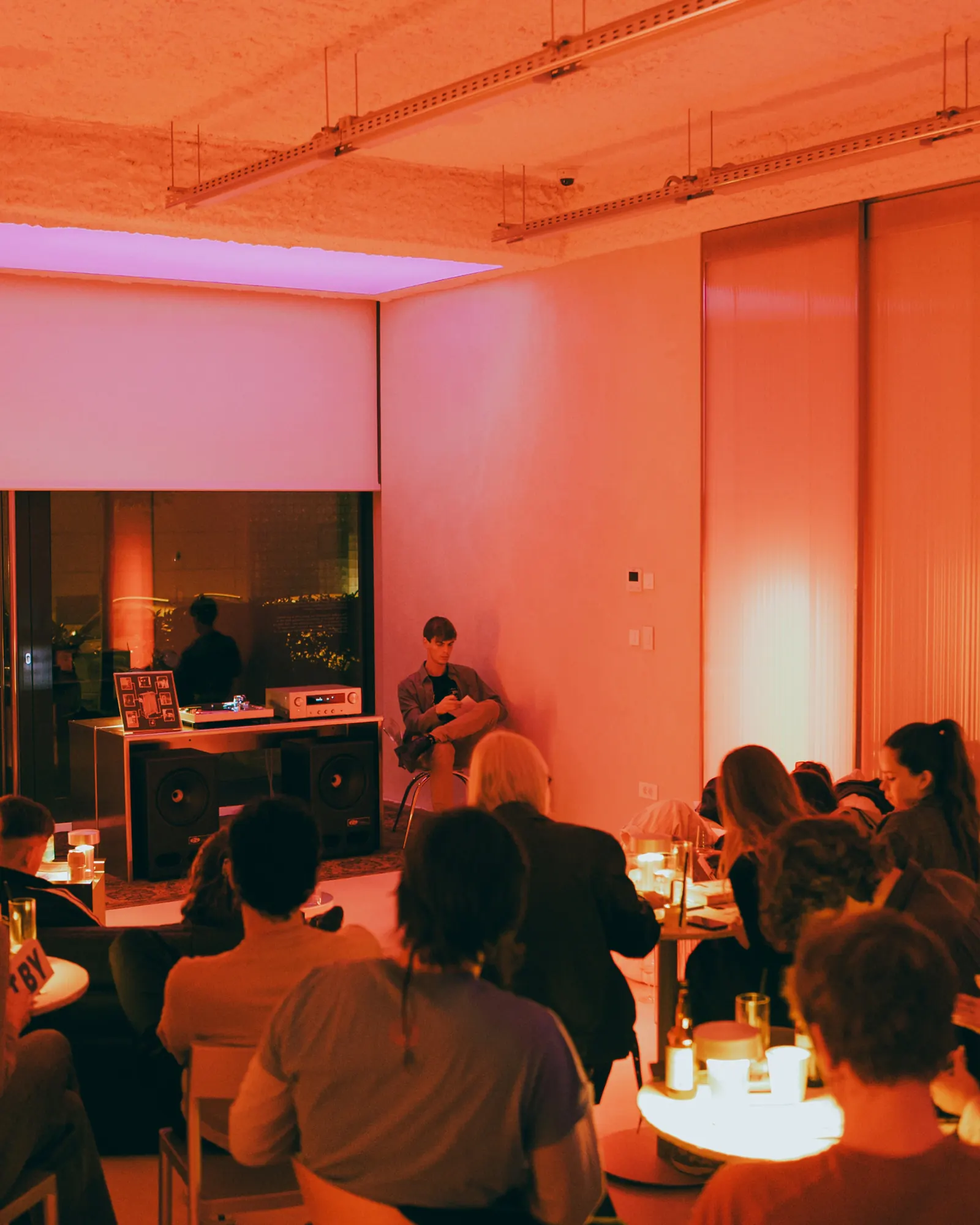 A listening session on the main floor, the audience seated around low tables
