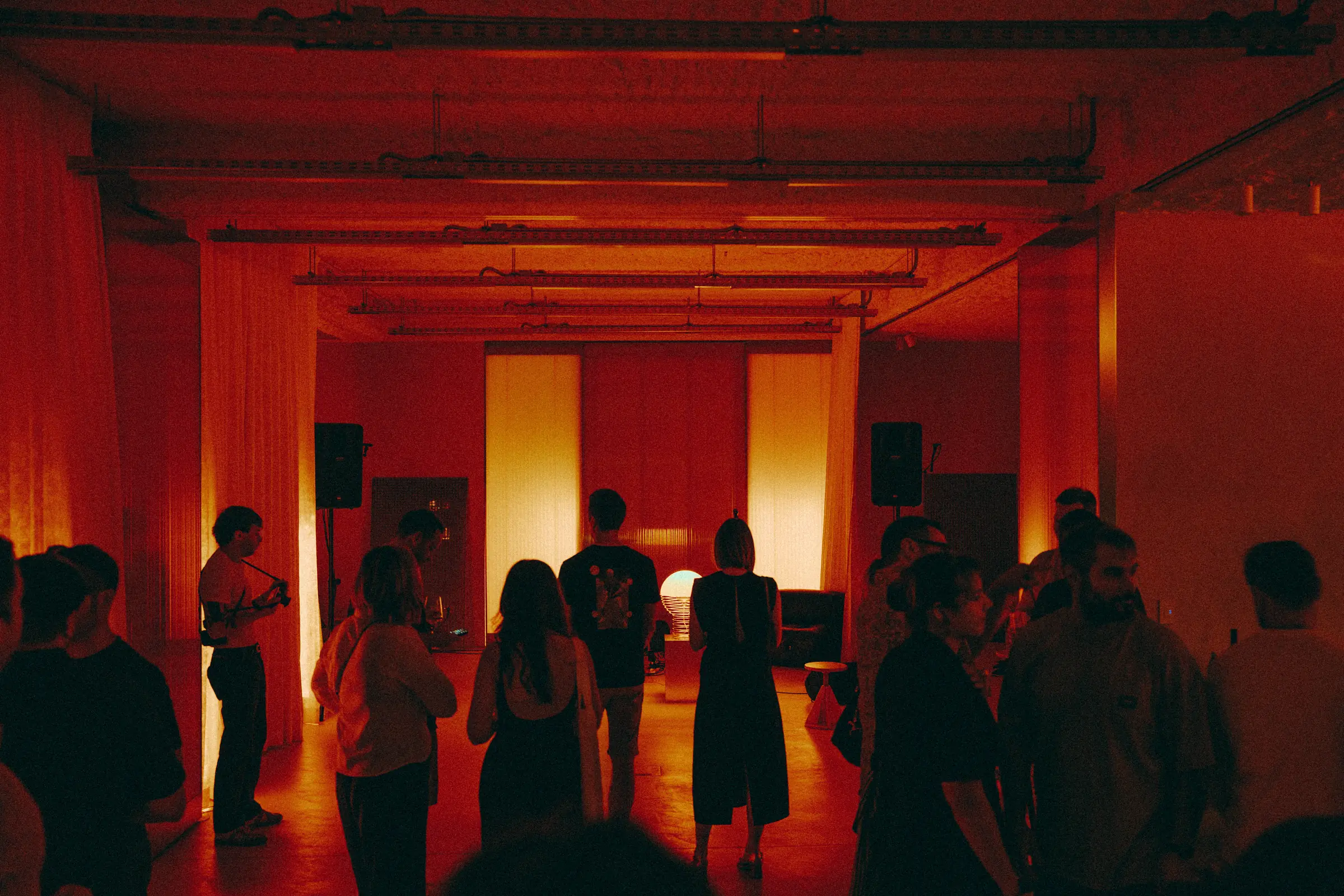 The room filling before the music starts