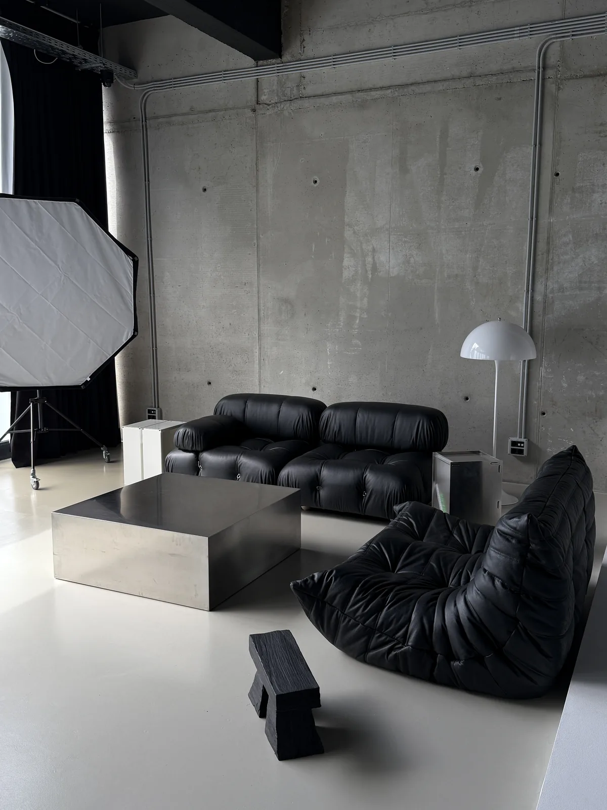 A lounge set built in the photo studio: Camaleonda, Togo and a steel table
