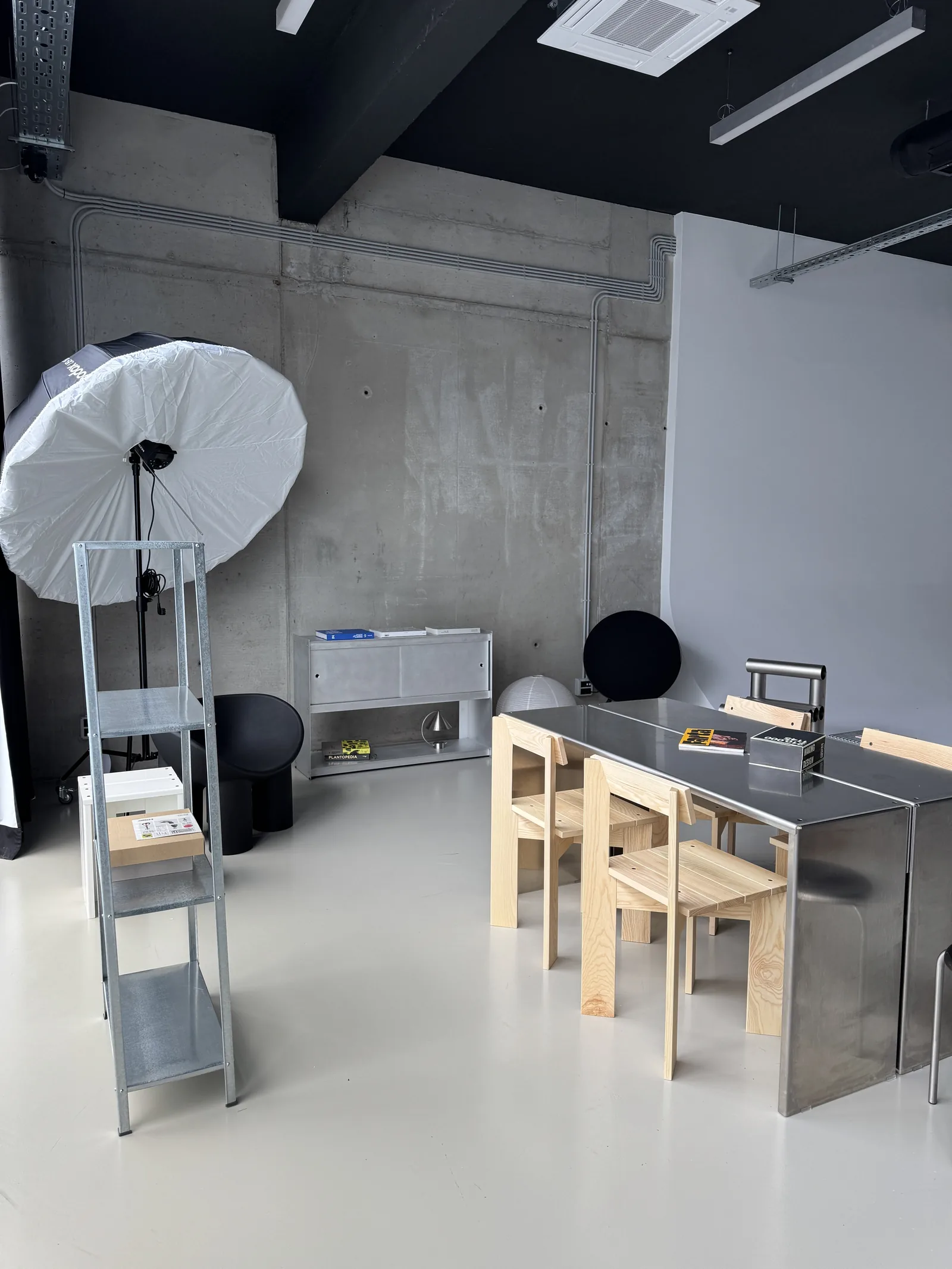 Workshop chairs around a steel table in the studio