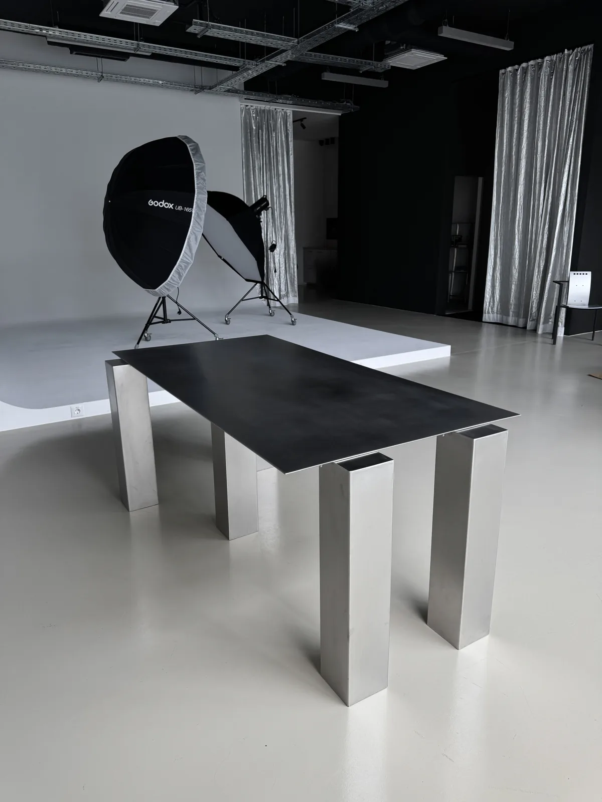 Black steel table on a white floor