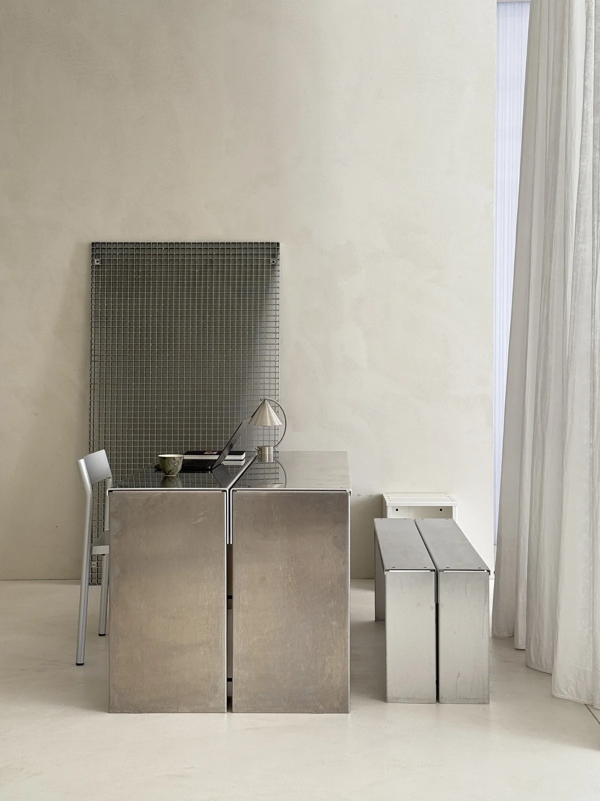 Steel cubes and a mesh screen in the white studio