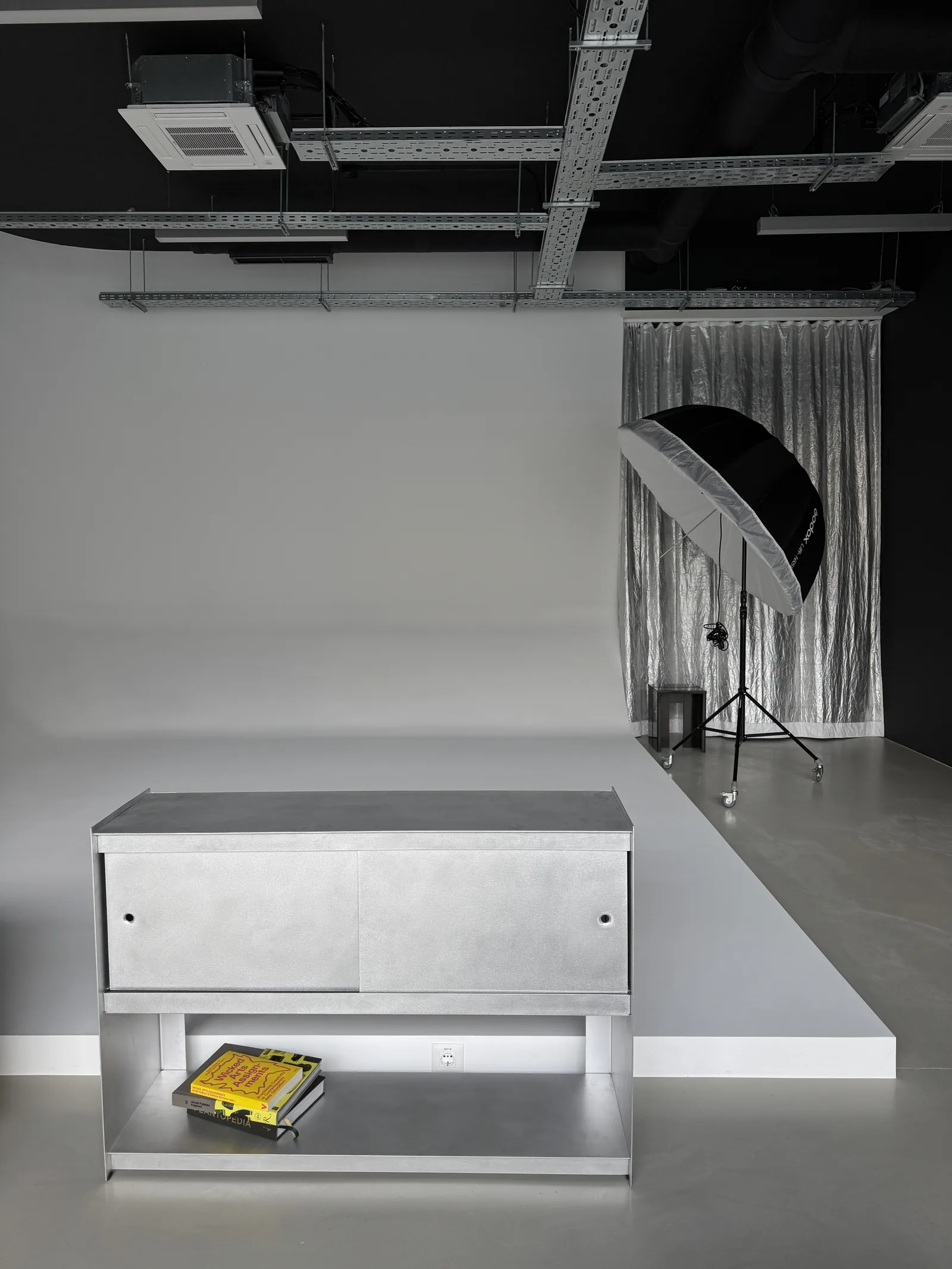Stainless steel cabinet on a plinth in the studio