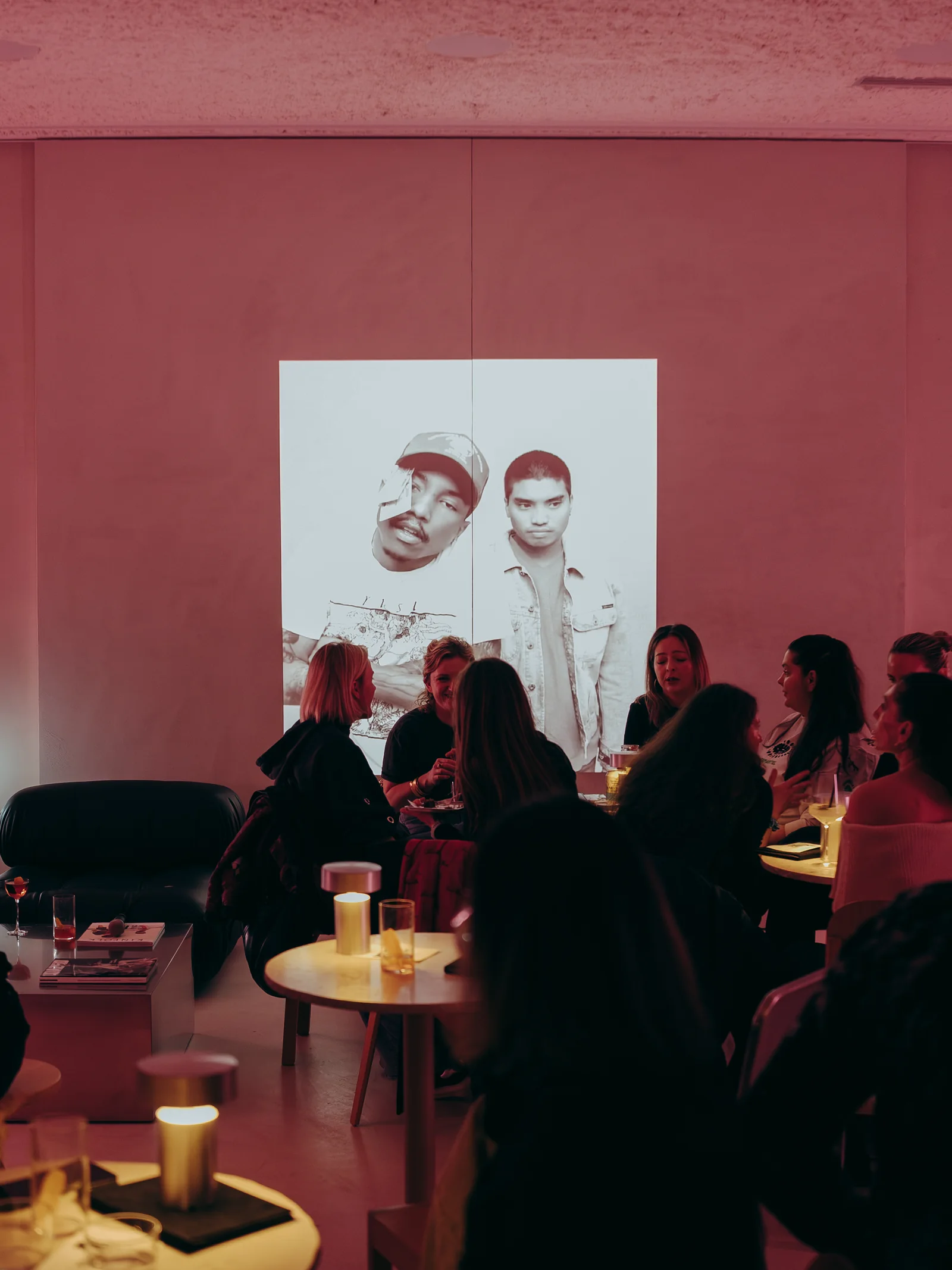 The floor at Holographik Space during the previous edition of The Drop by Taste, tables under pink light and the projection on the wall