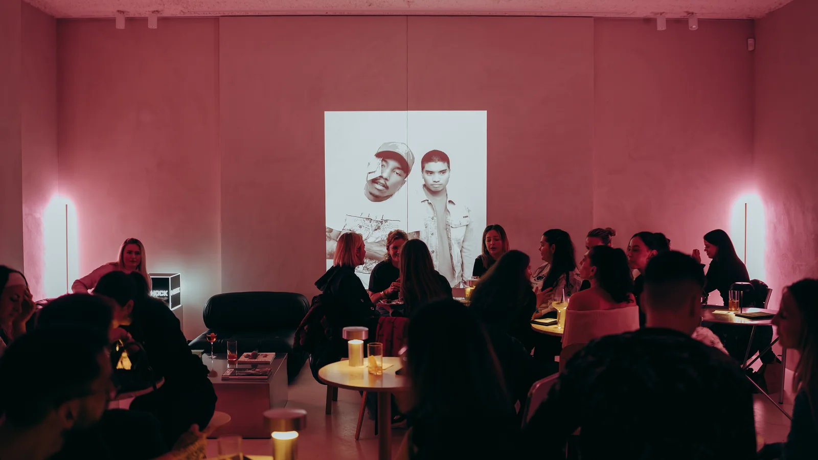 The floor at Holographik Space during the previous edition of The Drop by Taste, tables under pink light and the projection on the wall