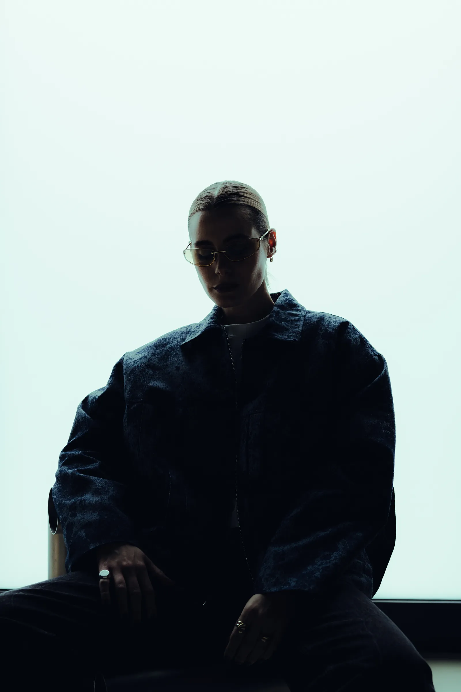 Portrait shot against a pale wall